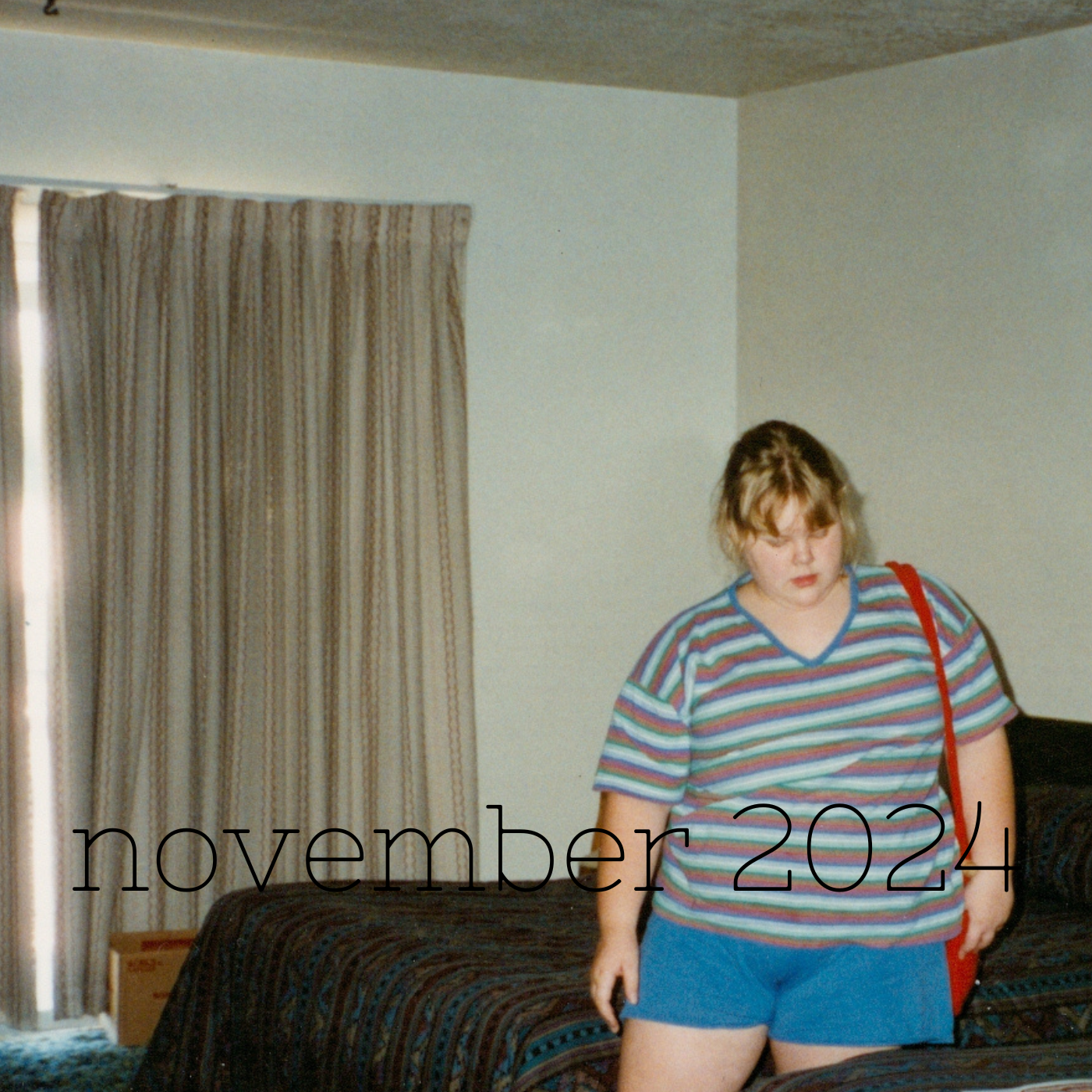 a square image of a kid anywhere from nine to twelve dressed in a tshirt and shorts standing in the scuzzy motel room in ogden, utah where they would get lice