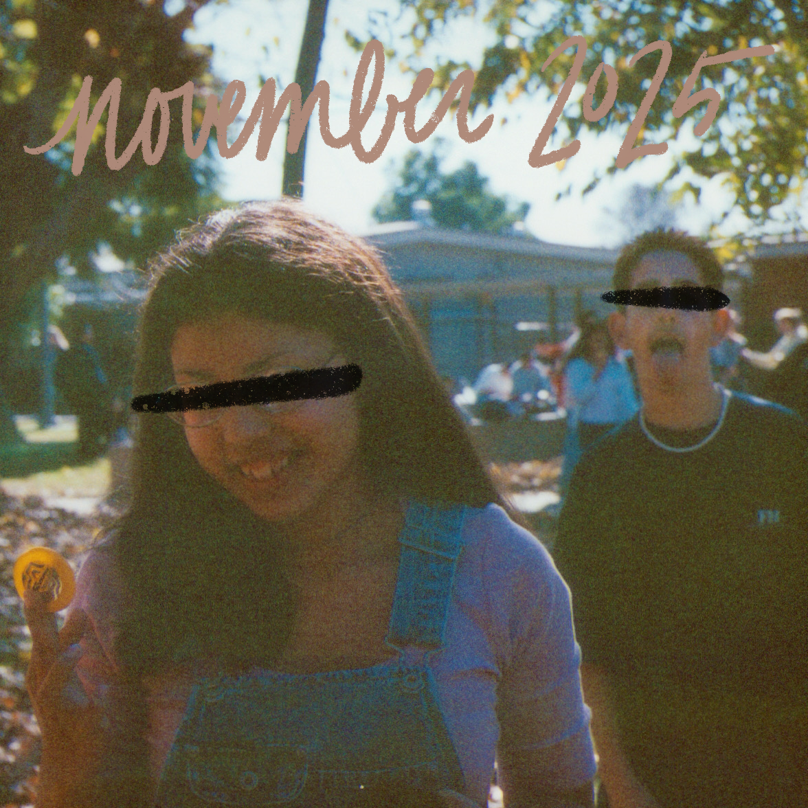 a square image of a teenage girl smiling at something she has in her hand, a teenage boy behind her sticking his tongue out, november 2025 is written in dusty pink script, the picture was likely taken in 1999 or 2000